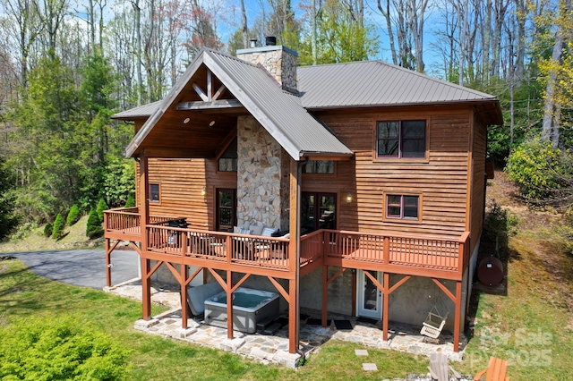 40 Ollis Ridge Ln, Elk Park, NC 28622 - back of property with a chimney, a deck, a yard, and metal roof
