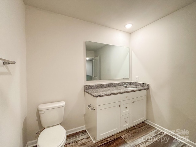 414 1st Ave SE, Hickory, NC 28602 - bathroom with vanity, wood finished floors, toilet, baseboards, and recessed lighting