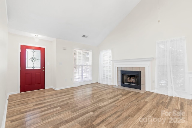 131 Canopy Ct, Mooresville, NC 28115 - unfurnished living room with wood finished floors, high vaulted ceiling, and a fireplace