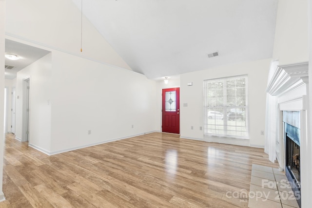 131 Canopy Ct, Mooresville, NC 28115 - unfurnished living room with high vaulted ceiling, light wood finished floors, and a premium fireplace