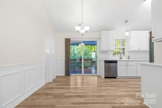 131 Canopy Ct, Mooresville, NC 28115 - kitchen featuring dishwasher, a chandelier, light countertops, white cabinets, and light wood-style floors