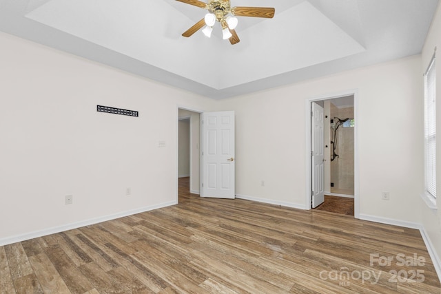 131 Canopy Ct, Mooresville, NC 28115 - unfurnished bedroom with wood finished floors, a raised ceiling, and a ceiling fan