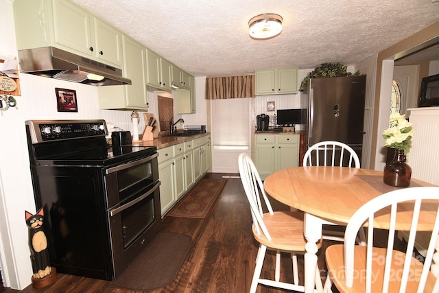 19 Mingus St, Canton, NC 28716 - kitchen with under cabinet range hood, range with two ovens, green cabinets, freestanding refrigerator, and a textured ceiling