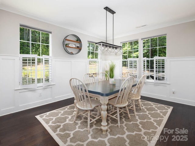 4237 Island Fox Ln, Denver, NC 28037 - dining space with a decorative wall, wainscoting, dark wood-type flooring, ornamental molding, and plenty of natural light