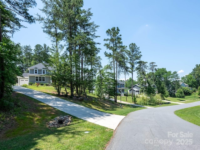 4237 Island Fox Ln, Denver, NC 28037 - view of community with a lawn, a residential view, driveway, and a garage