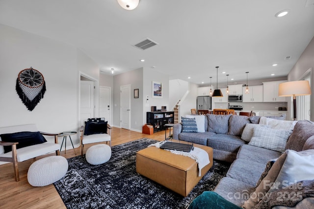1315 Elizabeth Ave, Kannapolis, NC 28083 - living room with light wood-style floors, recessed lighting, and stairway