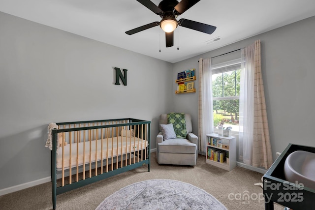 1315 Elizabeth Ave, Kannapolis, NC 28083 - bedroom with carpet floors, a crib, and a ceiling fan