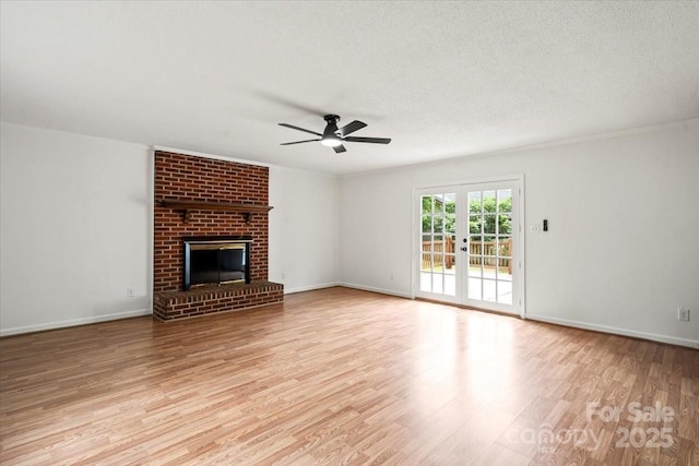 1512 Anthony Dr, Gastonia, NC 28052 - unfurnished living room featuring ceiling fan, wood finished floors, a brick fireplace, and a textured ceiling
