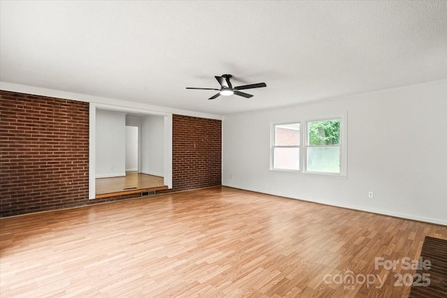 1512 Anthony Dr, Gastonia, NC 28052 - spare room with ceiling fan, light wood finished floors, and brick wall
