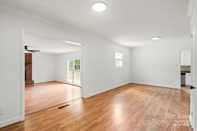 1512 Anthony Dr, Gastonia, NC 28052 - unfurnished room with ornamental molding, light wood-type flooring, ceiling fan, and a fireplace