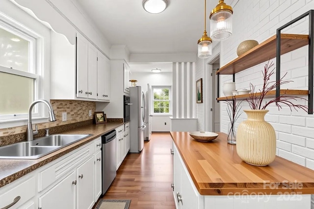 1512 Anthony Dr, Gastonia, NC 28052 - kitchen featuring appliances with stainless steel finishes, butcher block countertops, wood finished floors, and white cabinetry