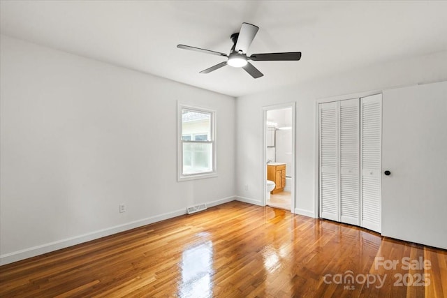 1512 Anthony Dr, Gastonia, NC 28052 - unfurnished bedroom with wood finished floors, ensuite bath, a closet, and a ceiling fan