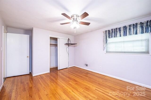 2836 20th Street Ln NE, Hickory, NC 28601 - unfurnished bedroom featuring baseboards, a closet, light wood-style floors, and a ceiling fan