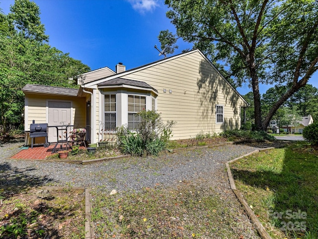 9337 Four Mile Creek Rd Unit 101, Charlotte, NC 28277 - view of property exterior featuring a chimney