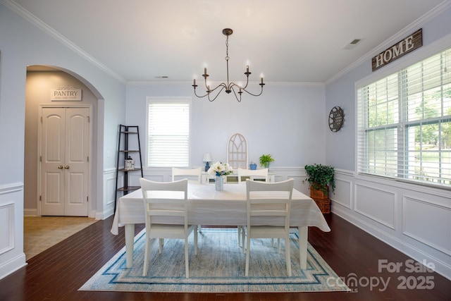2405 Emma Grace Ln, Rock Hill, SC 29732 - dining area featuring a chandelier, wood finished floors, crown molding, arched walkways, and wainscoting