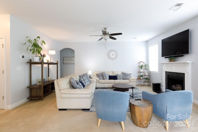 2405 Emma Grace Ln, Rock Hill, SC 29732 - living room featuring ceiling fan, light colored carpet, arched walkways, and a premium fireplace