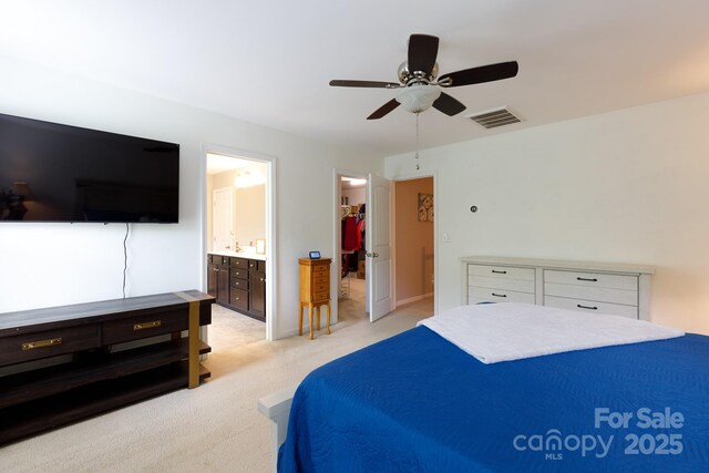 2405 Emma Grace Ln, Rock Hill, SC 29732 - bedroom with light colored carpet, a spacious closet, ensuite bathroom, a ceiling fan, and a closet