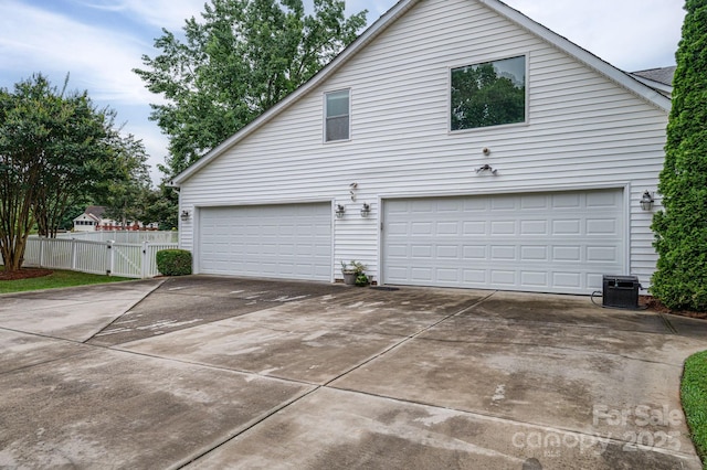 13403 Kensal Green Dr, Charlotte, NC 28278 - view of side of home with a gate, driveway, and an attached garage