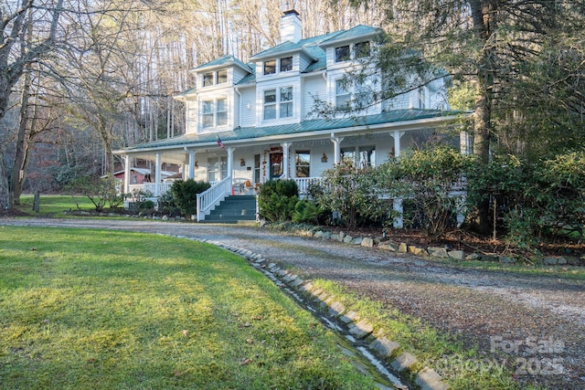 4584 NC Highway 194 S, Banner Elk, NC 28604 - view of front of house with covered porch, a chimney, a front yard, and a metal roof