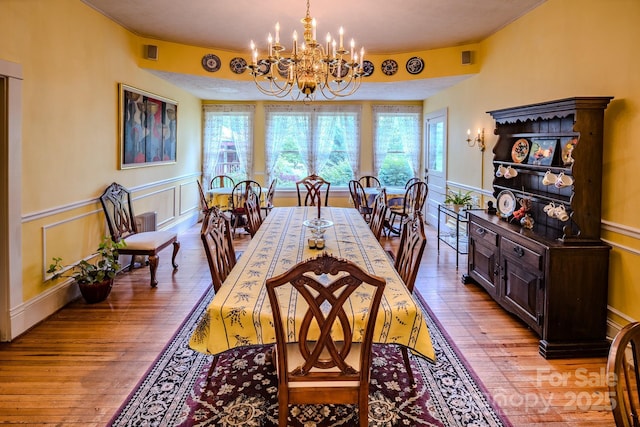4584 NC Highway 194 S, Banner Elk, NC 28604 - dining room with a chandelier, light wood-type flooring, and wainscoting