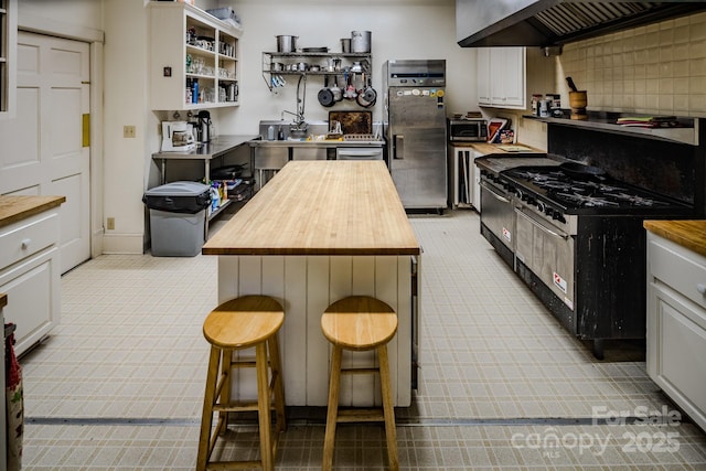 4584 NC Highway 194 S, Banner Elk, NC 28604 - kitchen with wooden counters, fridge with ice dispenser, stainless steel microwave, and premium range hood