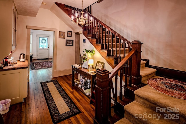 4584 NC Highway 194 S, Banner Elk, NC 28604 - staircase with wood-type flooring and a chandelier