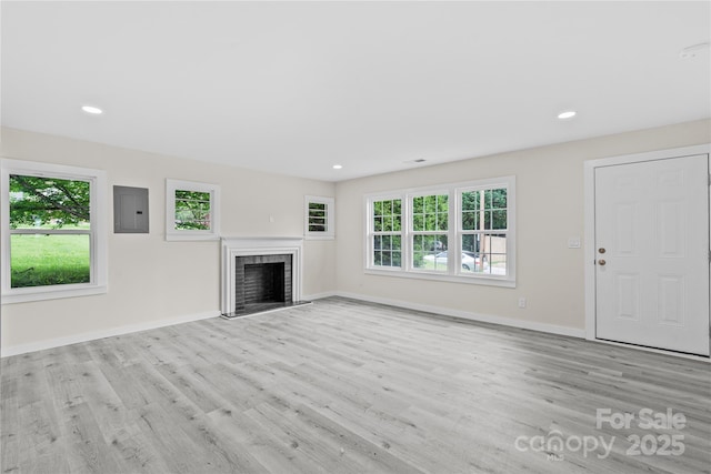 1017 W Fisher St, Salisbury, NC 28144 - unfurnished living room with wood finished floors, a fireplace, electric panel, and recessed lighting