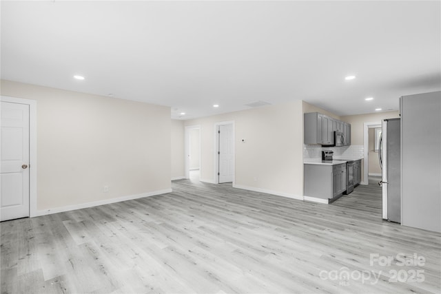 1017 W Fisher St, Salisbury, NC 28144 - unfurnished living room with light wood-style flooring and recessed lighting