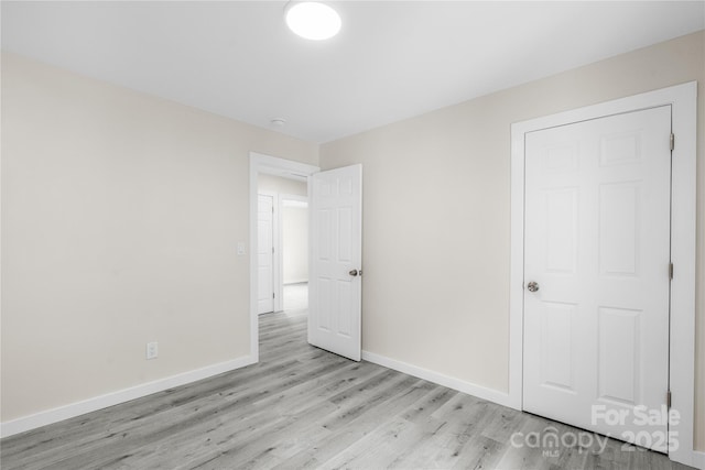 1017 W Fisher St, Salisbury, NC 28144 - unfurnished bedroom featuring light wood-style flooring and baseboards