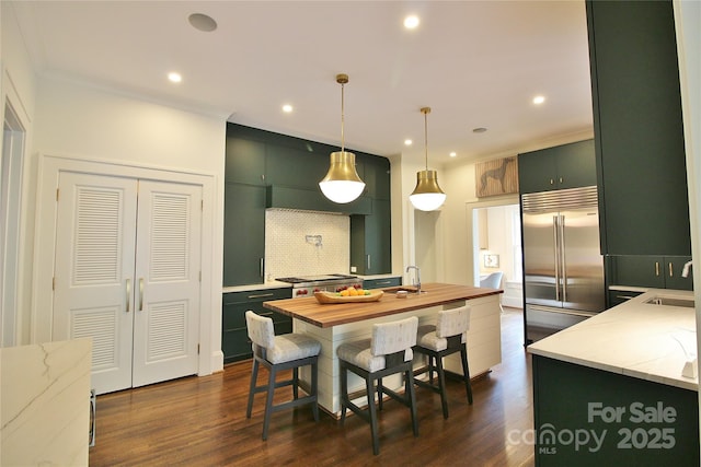 1137 Queens Rd W, Charlotte, NC 28207 - kitchen with built in fridge, green cabinets, dark wood-style floors, recessed lighting, and crown molding
