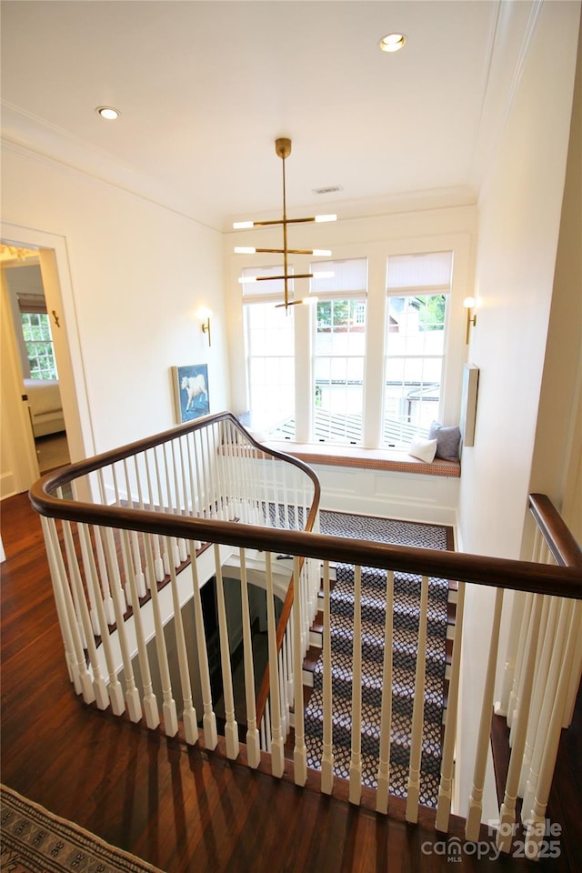 1137 Queens Rd W, Charlotte, NC 28207 - stairway featuring wood finished floors, plenty of natural light, ornamental molding, a chandelier, and recessed lighting
