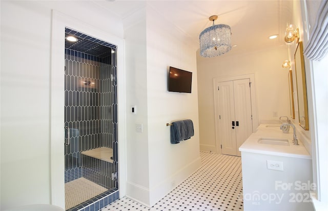 1137 Queens Rd W, Charlotte, NC 28207 - bathroom featuring a stall shower, double vanity, baseboards, a chandelier, and crown molding
