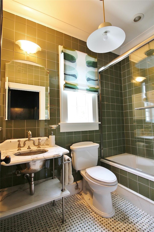 1137 Queens Rd W, Charlotte, NC 28207 - full bathroom with tile walls, tiled shower / bath combo, toilet, and tile patterned flooring