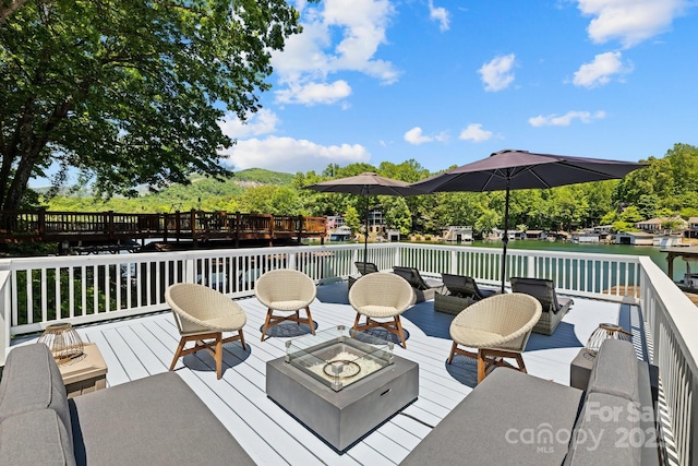 174 Ridge Rd, Lake Lure, NC 28746 - wooden terrace featuring an outdoor fire pit and a water view