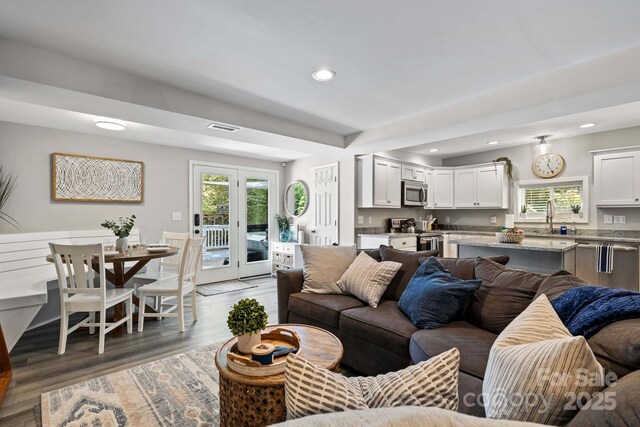 174 Ridge Rd, Lake Lure, NC 28746 - living room featuring wood finished floors, recessed lighting, and french doors
