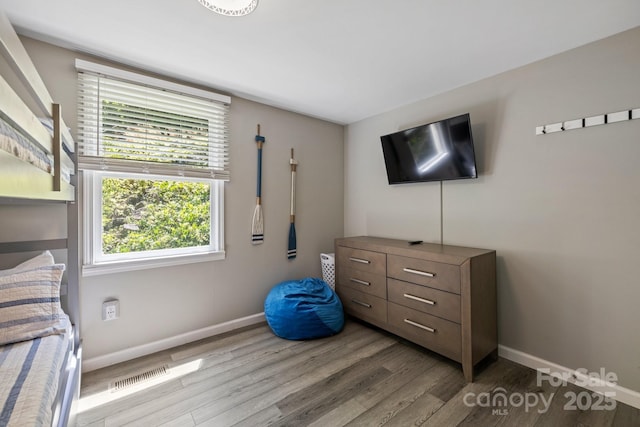 174 Ridge Rd, Lake Lure, NC 28746 - bedroom with wood finished floors and multiple windows