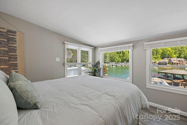 174 Ridge Rd, Lake Lure, NC 28746 - bedroom featuring vaulted ceiling, wood finished floors, and a water view