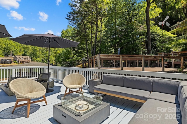 174 Ridge Rd, Lake Lure, NC 28746 - deck featuring an outdoor living space with a fire pit and view of wooded area