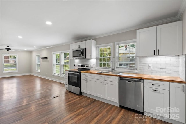 321 E Taylor St, Landis, NC 28088 - kitchen with wood counters, stainless steel appliances, a sink, crown molding, and dark wood finished floors