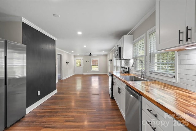 321 E Taylor St, Landis, NC 28088 - kitchen featuring stainless steel appliances, wood counters, a sink, crown molding, and dark wood-style floors