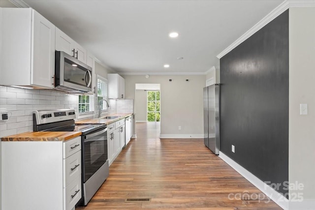 321 E Taylor St, Landis, NC 28088 - kitchen featuring stainless steel appliances, butcher block countertops, a sink, ornamental molding, and recessed lighting