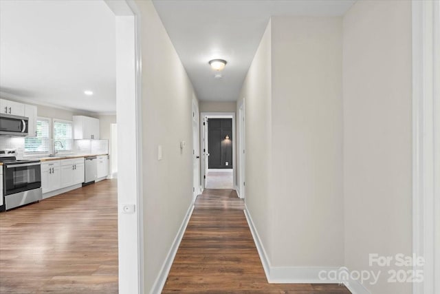 321 E Taylor St, Landis, NC 28088 - hallway featuring wood finished floors, baseboards, and a sink