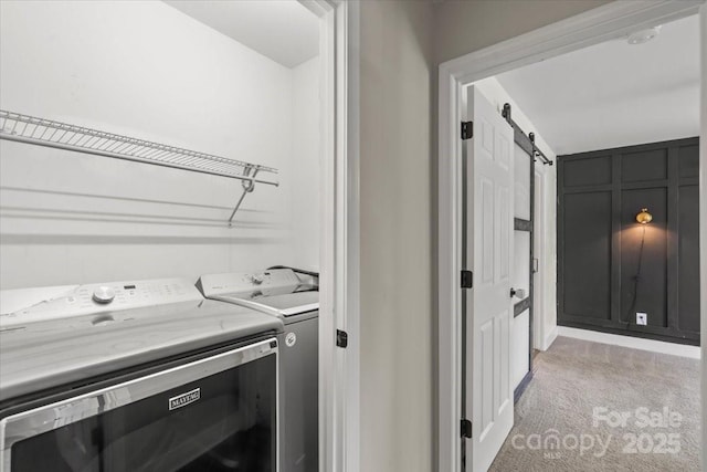 321 E Taylor St, Landis, NC 28088 - laundry area with light colored carpet, washing machine and clothes dryer, and a barn door