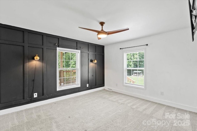 321 E Taylor St, Landis, NC 28088 - spare room featuring light carpet, a ceiling fan, a decorative wall, and baseboards