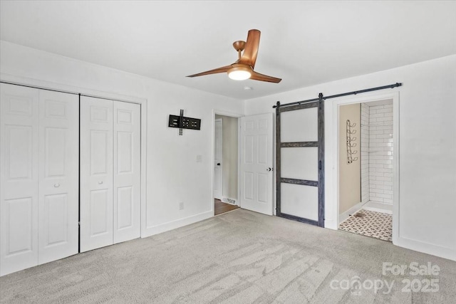 321 E Taylor St, Landis, NC 28088 - unfurnished bedroom featuring carpet floors, a barn door, a closet, and baseboards