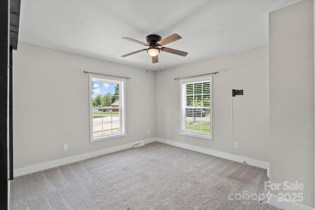 321 E Taylor St, Landis, NC 28088 - empty room with plenty of natural light, a ceiling fan, and baseboards