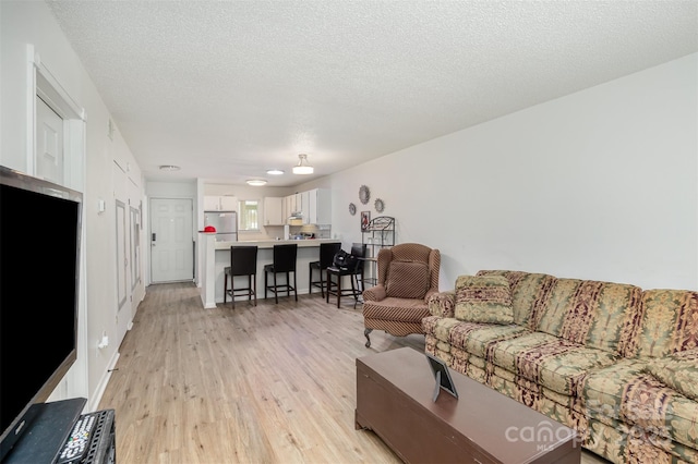 1602 Eagles Pl Unit J103, Rock Hill, SC 29732 - living area with light wood-style floors and a textured ceiling