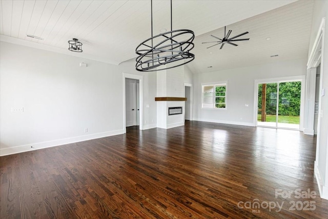 115 Augusta Ln, Shelby, NC 28150 - unfurnished living room with baseboards, a glass covered fireplace, dark wood-style flooring, ceiling fan, and lofted ceiling