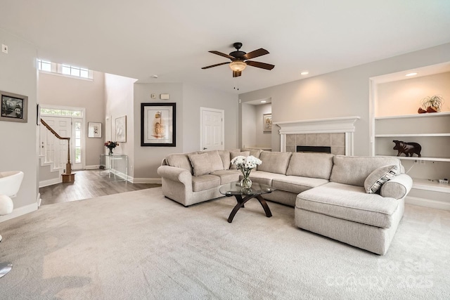 5832 Lagrande Dr, Charlotte, NC 28269 - carpeted living room with stairway, a ceiling fan, a tile fireplace, recessed lighting, and baseboards