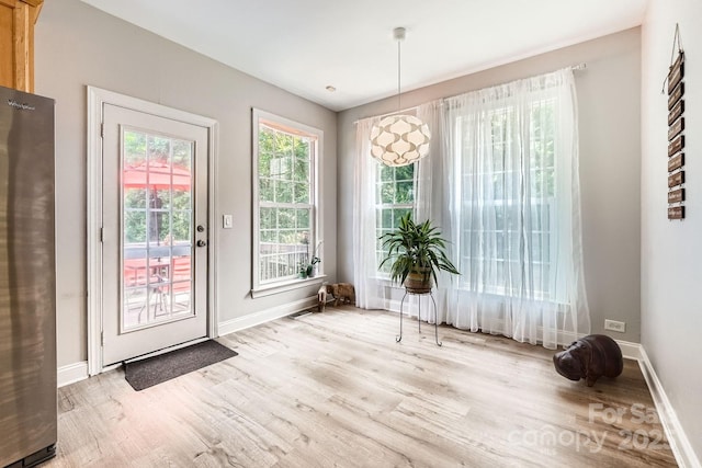5832 Lagrande Dr, Charlotte, NC 28269 - doorway to outside featuring light wood finished floors and baseboards